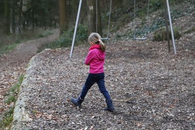 Rear view of girl walking at playground