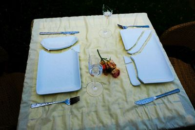 High angle view of broken plates and glasses on table