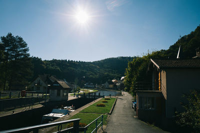 Street amidst trees against sky