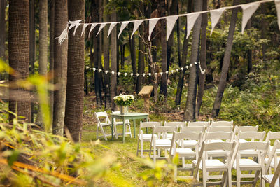 Table and chairs arranged for wedding ceremony