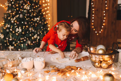 Portrait of boy playing with christmas tree