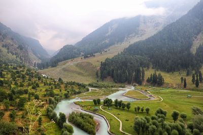 Scenic view of landscape and mountains against sky