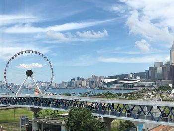 Ferris wheel in city against sky