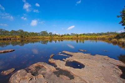 Scenic view of lake against blue sky