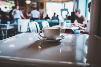 Close-up of coffee served on table at cafe