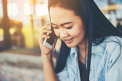 Young woman using mobile phone outdoors