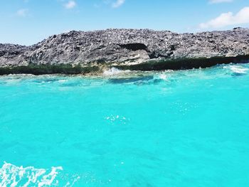 Swimming pool by sea against sky