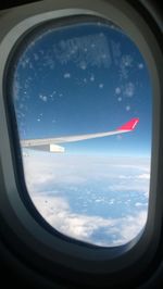 Cropped image of airplane wing over landscape