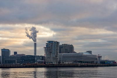 Smoke emitting from smoke stack in city