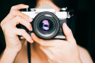 Midsection of man photographing camera