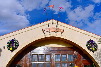 Low angle view of building against cloudy sky