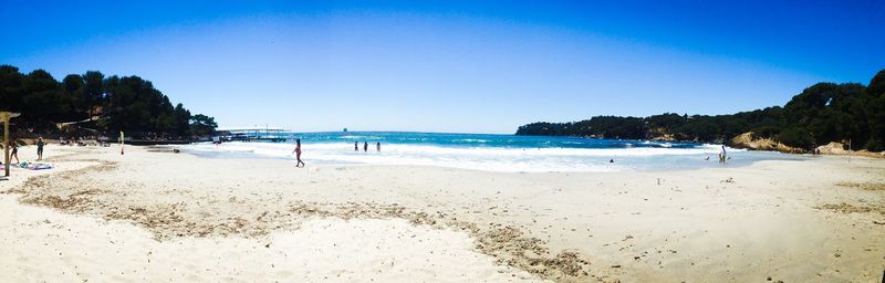 Scenic view of beach against blue sky