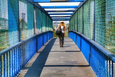 Full length of woman standing on railing