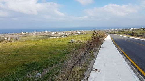 Panoramic view of road by sea against sky