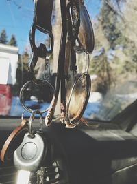 Close-up of sunglasses and keys hanging in cars