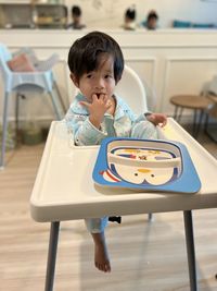 Portrait of boy playing with toy blocks at home