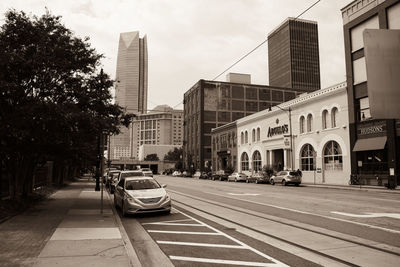 Cars on street amidst buildings in city