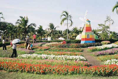 People amidst flowers at park