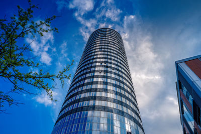 Low angle view of modern buildings against blue sky