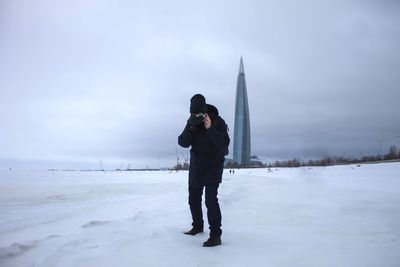 Full length of man standing on snow covered land