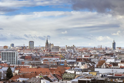 High angle view of city against cloudy sky