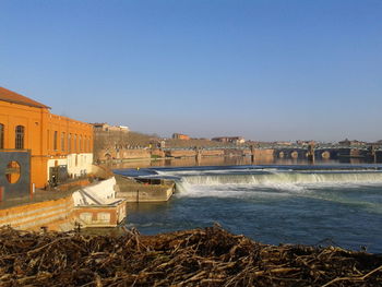 River water flowing against buildings