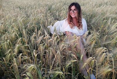 Portrait of smiling young woman standing in farm