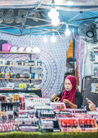 Portrait of woman standing at store