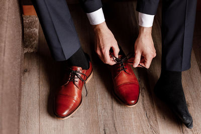 Businessman getting ready for work. putting his shoes on. man puts on his brown shoes.