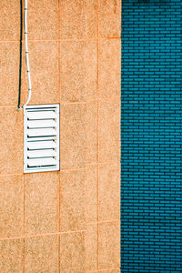 Full frame shot of blue bricks wall against window of building