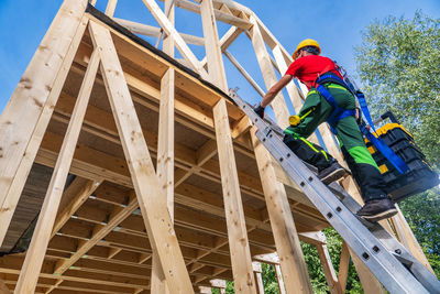 Low angle view of man working at construction site