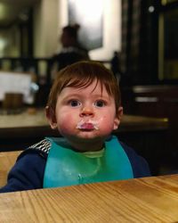 Close-up of cute baby boy sitting at restaurant