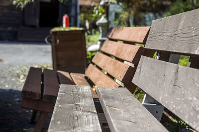 Empty wooden benches in backyard