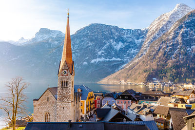 View of beautiful hallstatt famous church during morning sunrise in early spring with mountain range