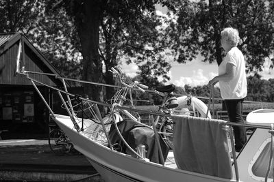 Man on boat against trees