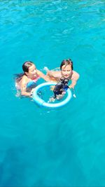 High angle view of young woman swimming in pool