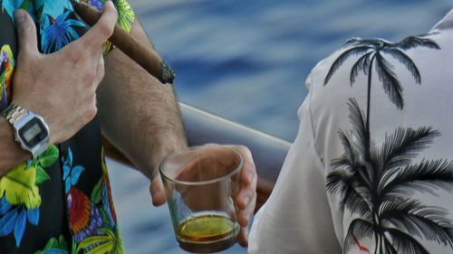 Panoramic view of man and woman drinking glass outdoors