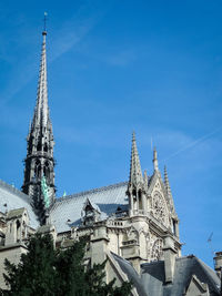 Low angle view of buildings against blue sky