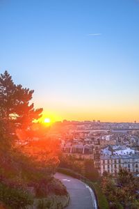 View of cityscape against clear sky at sunset