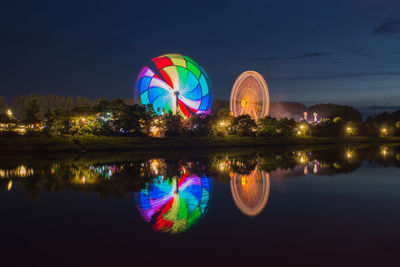 Scenic view of lake against sky at night