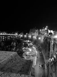 High angle view of illuminated street and buildings at night