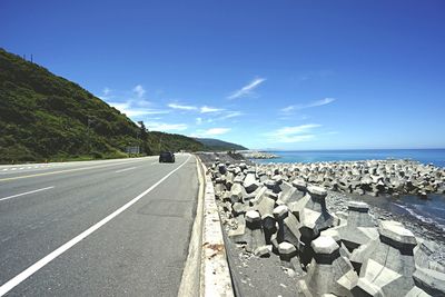 Empty road leading towards sea