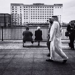 Rear view of people standing on street