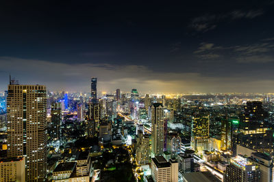 High angle view of illuminated city buildings at night