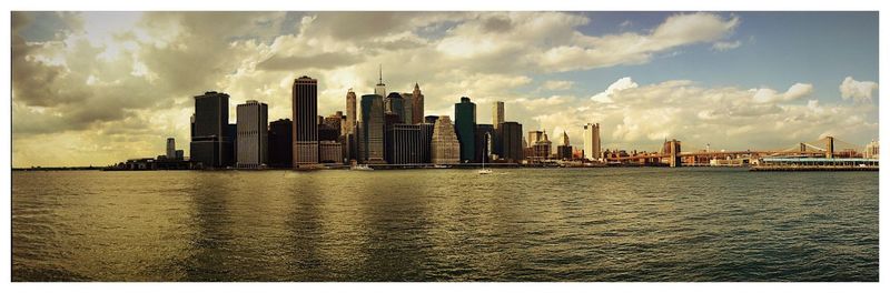 City skyline against cloudy sky