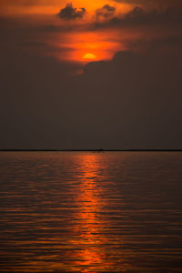 Scenic view of sea against romantic sky at sunset