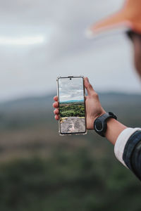 Man photographing with mobile phone