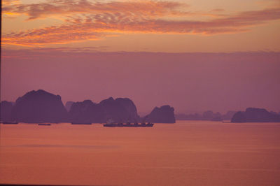 Scenic view of sea against romantic sky at sunset
