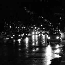 Cars on city street at night