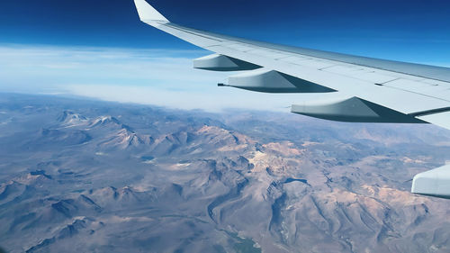 Aerial view of snowcapped mountain against sky